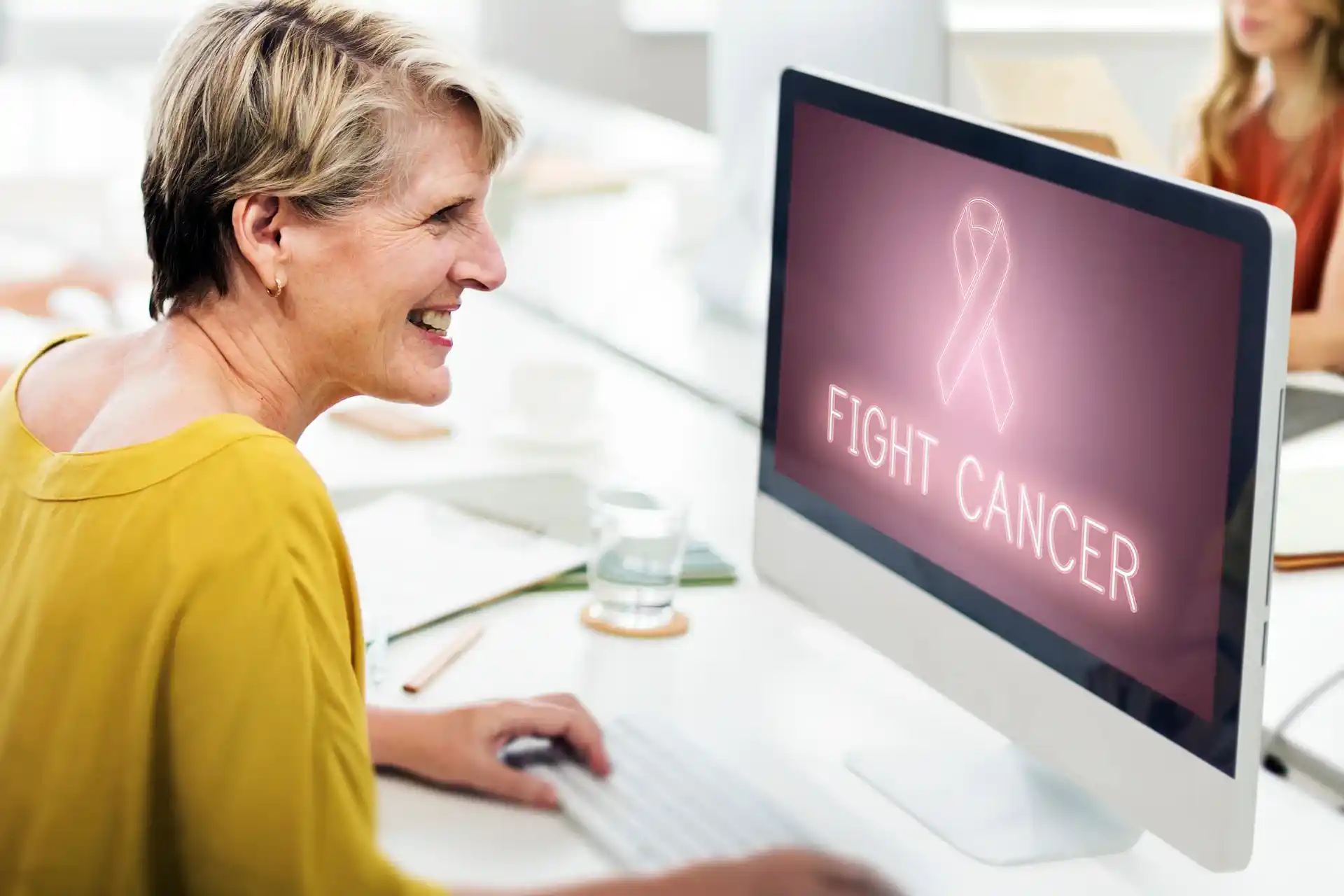 Lady with computer screen searching for cancer disease plans