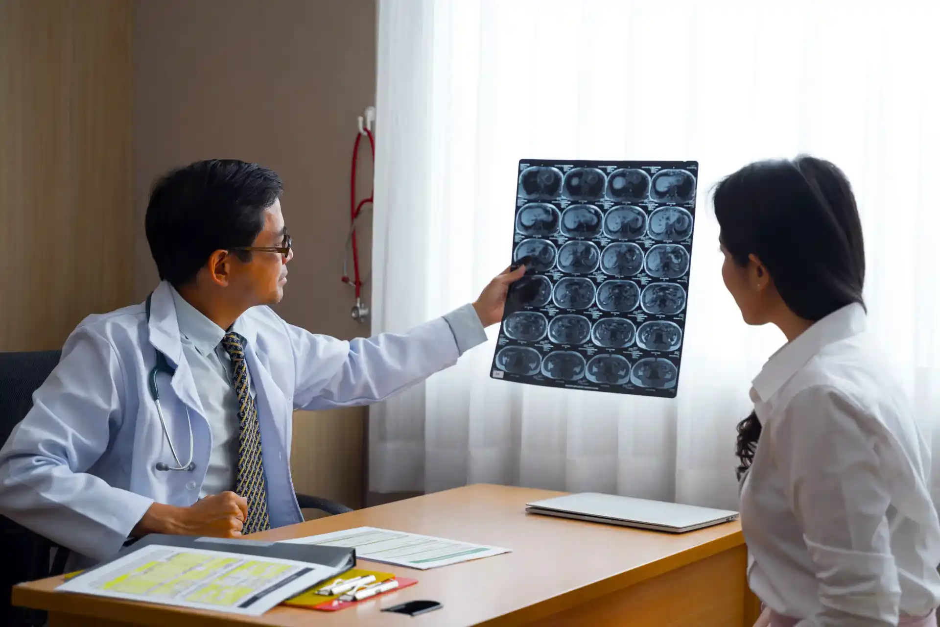 Doctor holding x-ray images against light