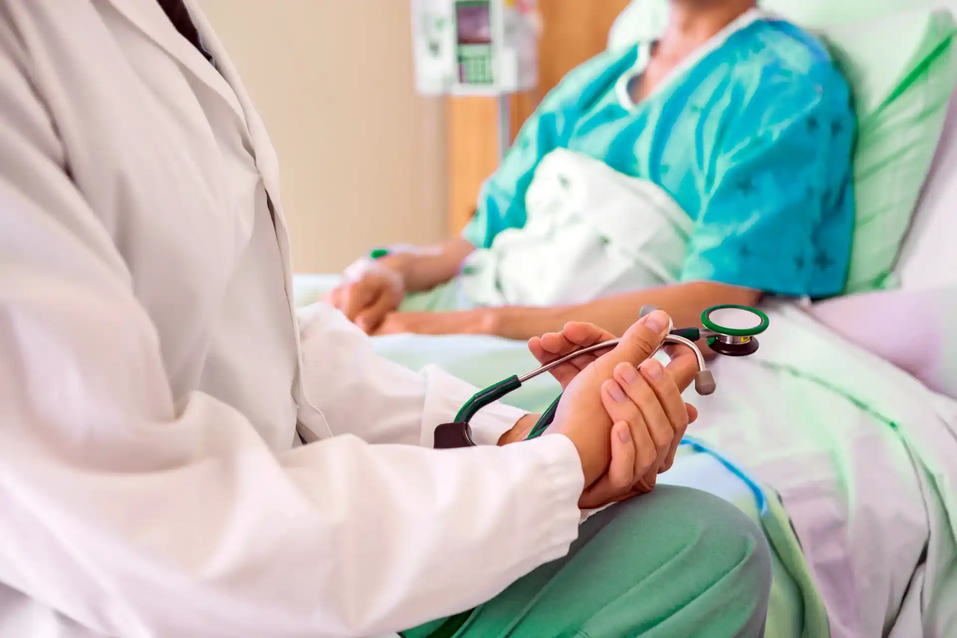 Female doctor by patient's bed