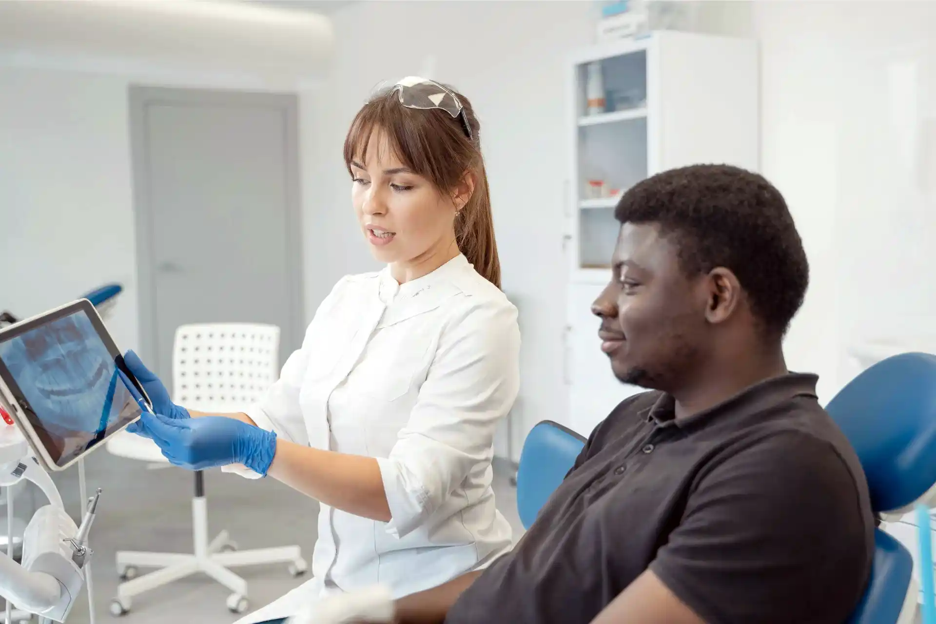 Patient with dental insurance receiving explanation by dental assistant