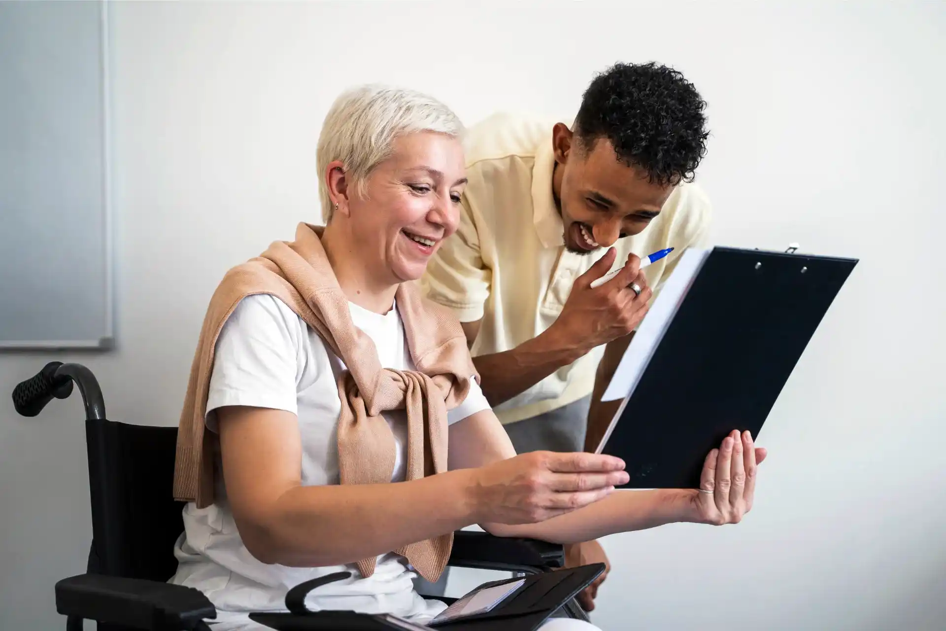 Lady with disability insurance in wheelchair reviewing document