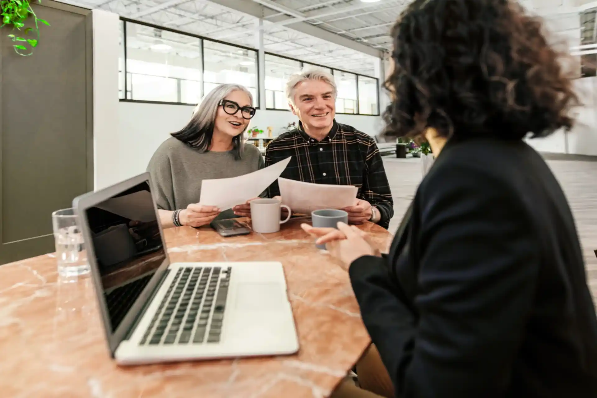 Insurance agent explaining final expense benefits to couple